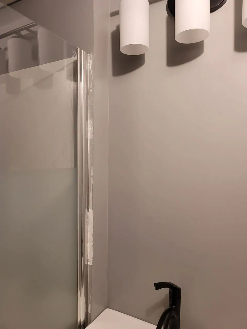 Basement bathroom with a corner glass shower, photo 3 of 9 (finished)
