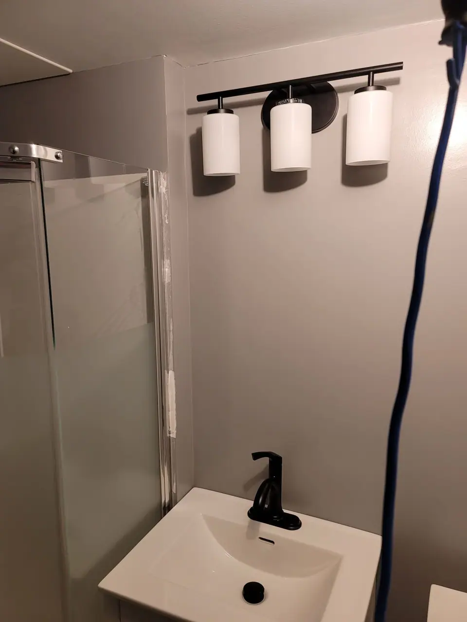 Basement bathroom with a corner glass shower, photo 5 of 9 (finished)