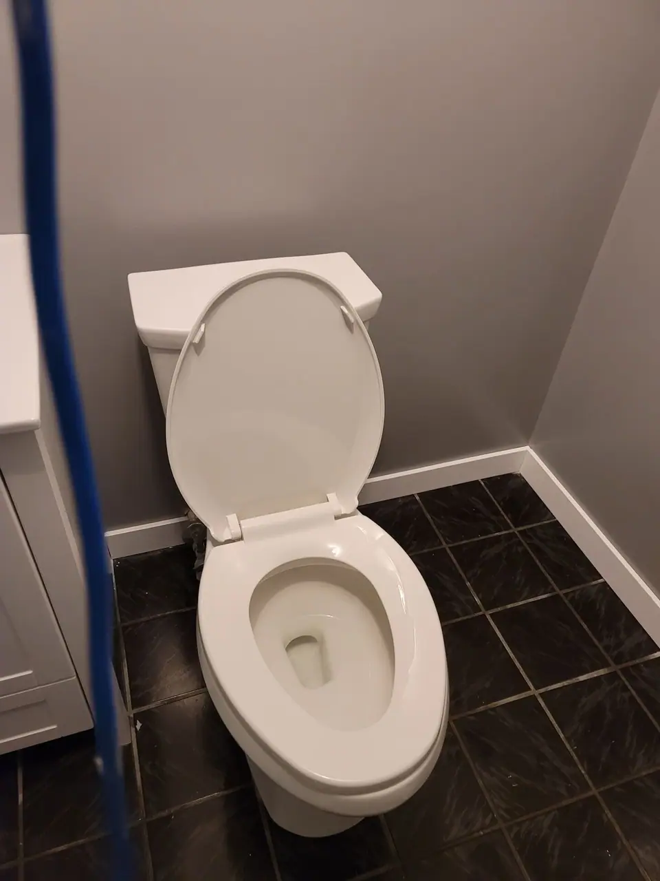 Basement bathroom with a corner glass shower, photo 7 of 9 (finished)