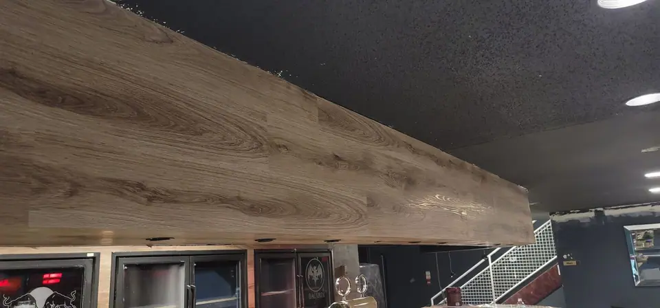 Commercial interior: curved wood-look bulkhead and service wall, photo 6 of 15