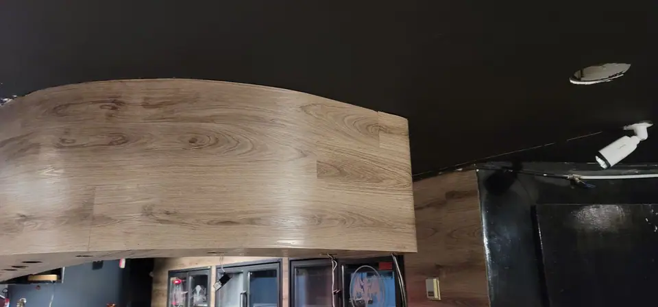Commercial interior: curved wood-look bulkhead and service wall, photo 8 of 15
