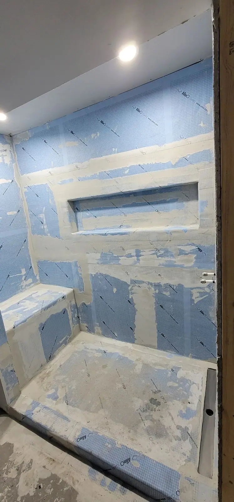 Walk-in shower, membrane to glass: waterproofing stage