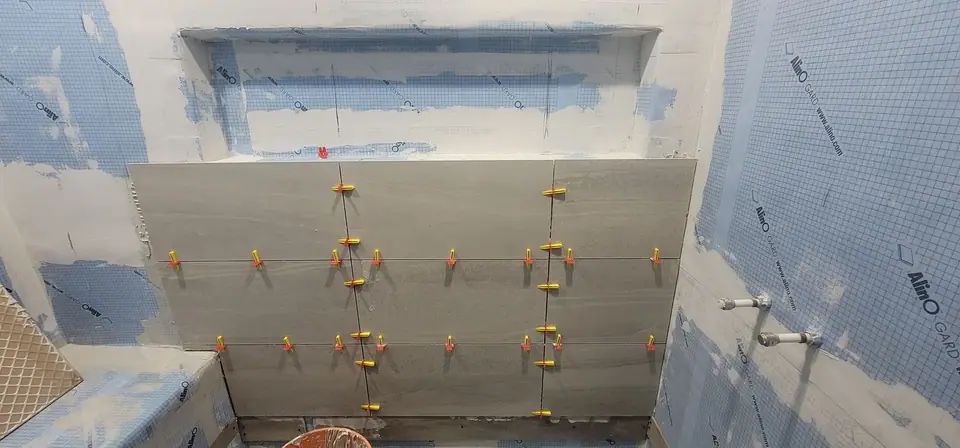 Basement suite bathroom: walk-in shower and stacked laundry, photo 16 of 30 (in progress)