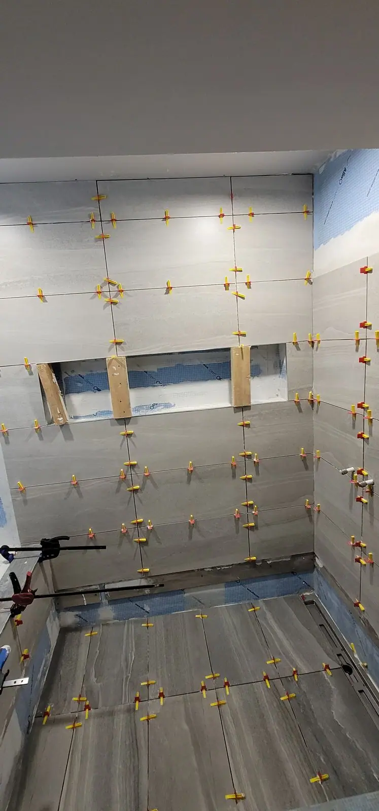 Basement suite bathroom: walk-in shower and stacked laundry, photo 19 of 30 (in progress)