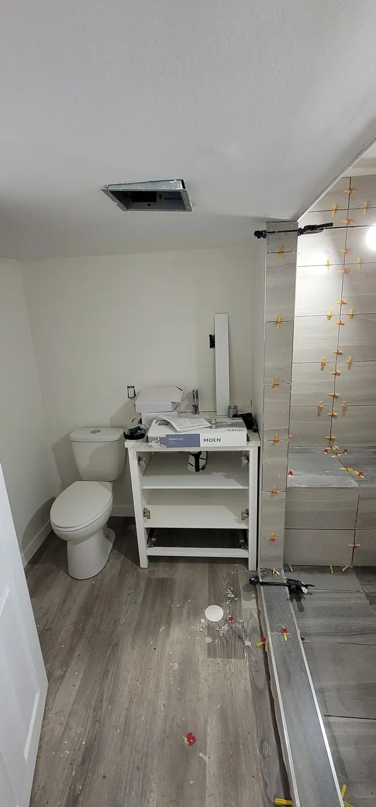 Basement suite bathroom: walk-in shower and stacked laundry, photo 22 of 30 (in progress)