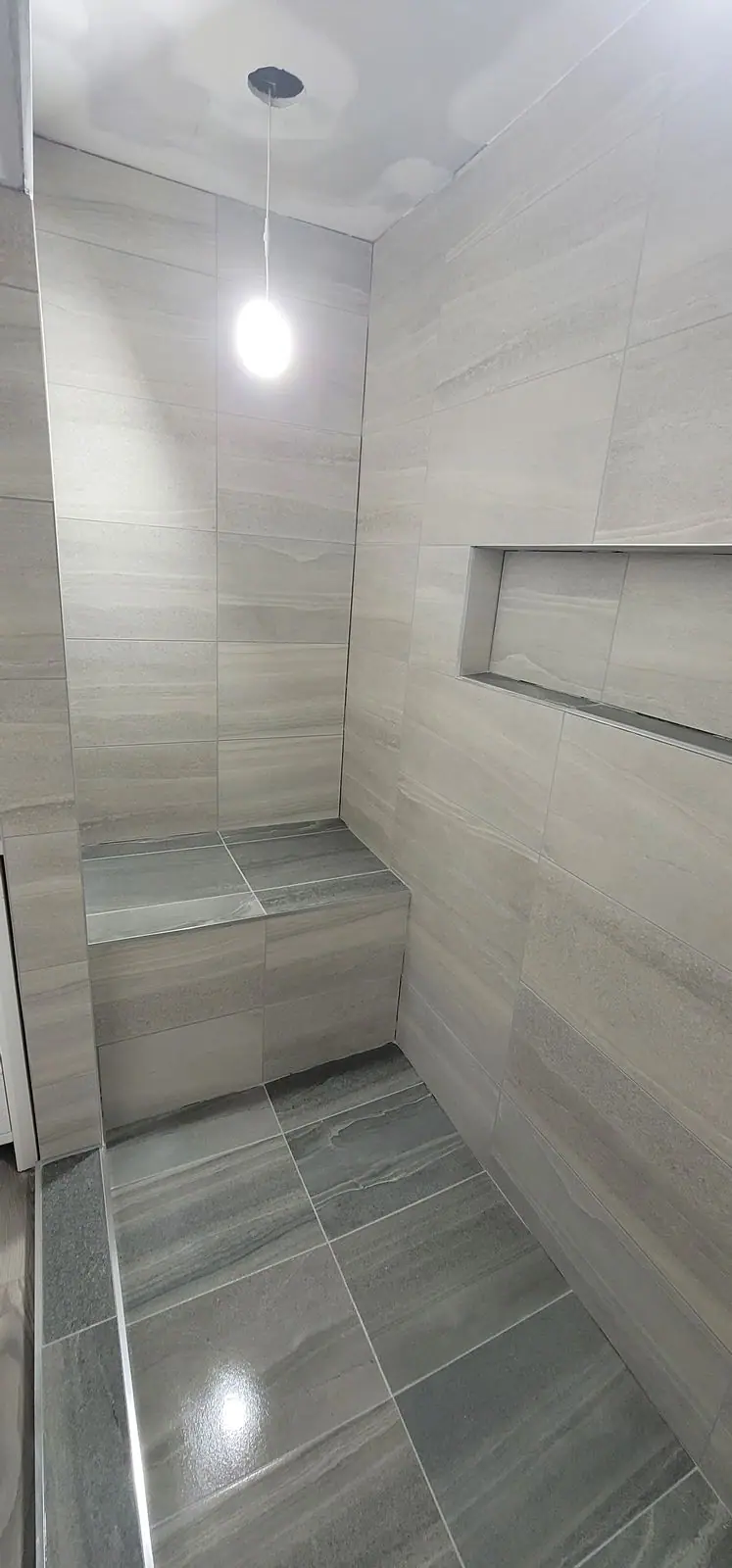 Basement suite bathroom: walk-in shower and stacked laundry, photo 27 of 30 (finished)