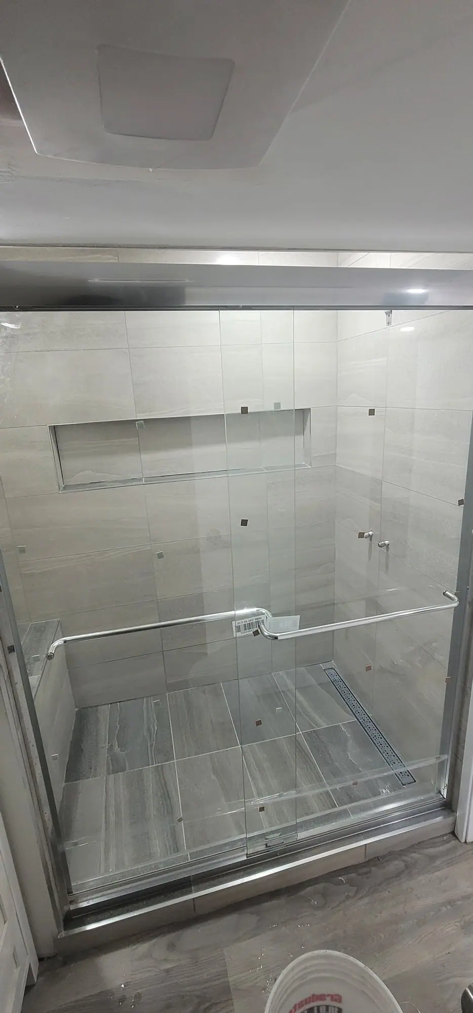 Basement suite bathroom: walk-in shower and stacked laundry, photo 29 of 30 (finished)